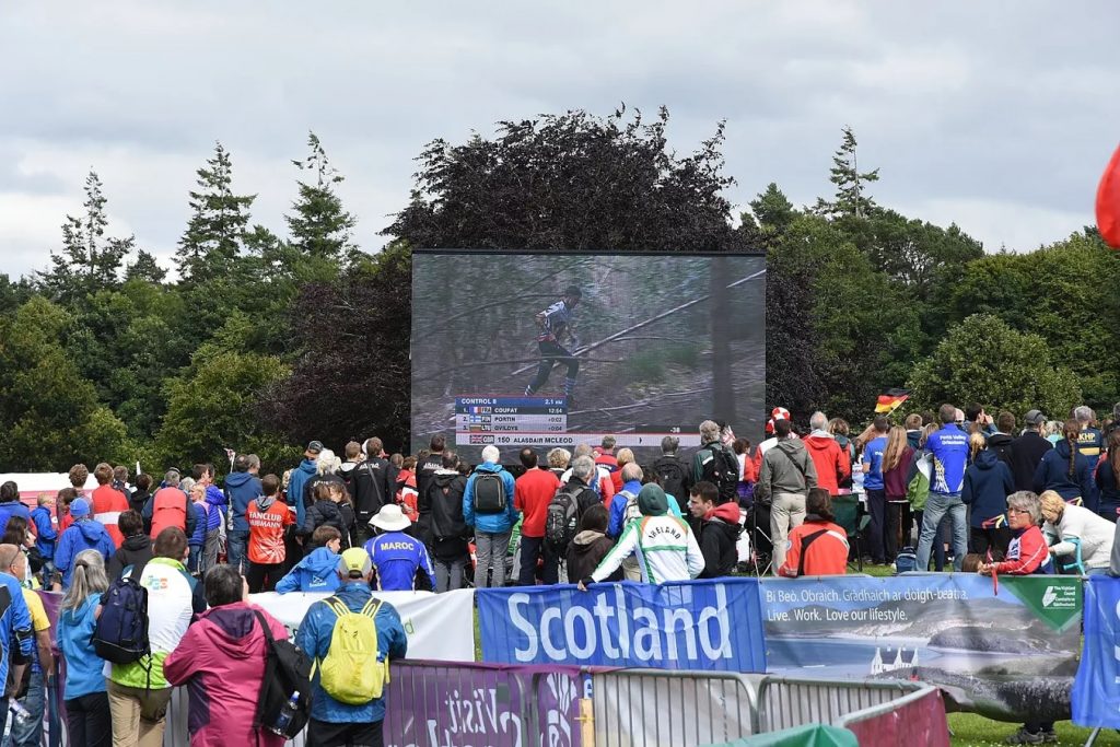 WOC crowd watching orienteering on large screen in the great outdoors