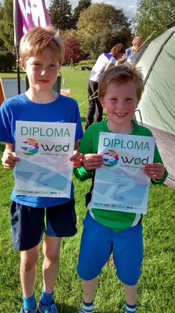 2 young orienteers with diplomas enjoying family activities