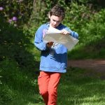 Young person orienteering in the Scottish countryside